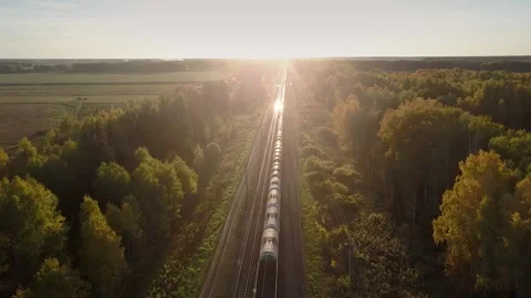 Aerial view setting sun shines on moving train cisterns 스톡 동영상 101572658