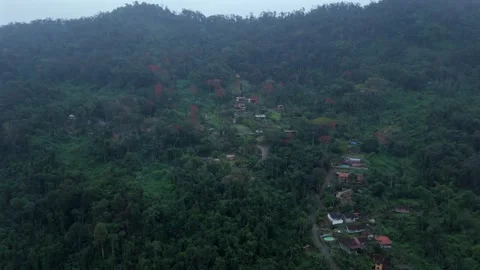 Aerial View Of A Settlement Within A Lush, Forested Mountain Landscape In Stock-Footage 331047967