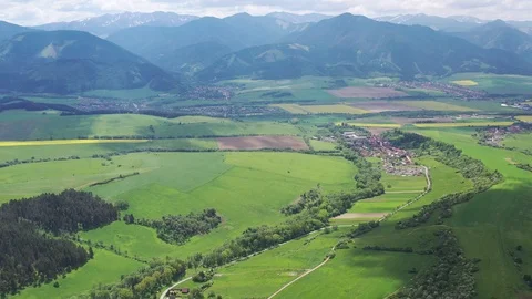 Aerial view of settlements, fields and pastures under High Tatra mountains Stock Footage 113932289