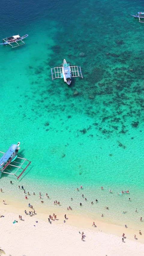 Aerial View of Seven Commandos Beach with Tourist Boats in El Nido, Philippines Stock Footage 348354503