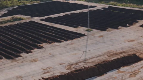 Aerial view of sewage sludge composting windrows in agricultural setting Stock Footage 344348174