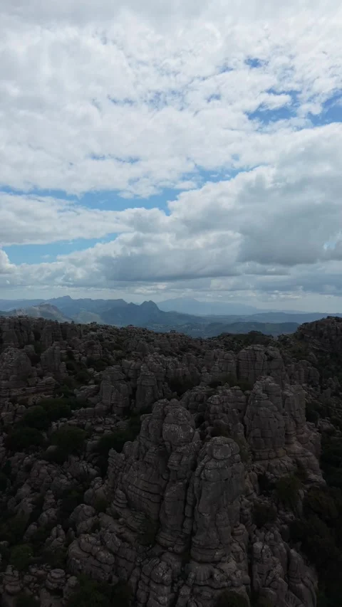 Aerial view of a shadowed karst plain under evening sky 스톡 동영상 343324270