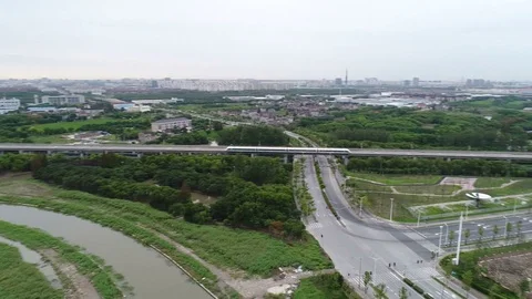 Aerial view of Shanghai magnetic levitation (maglev) train move fast on track Stock Footage