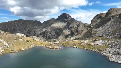 Aerial view of sharp granite spires and rocky slopes of the High Mountains Stock Footage 320117531
