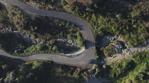Aerial view of a sharp hairpin bend mountain road Stock Footage 327959274