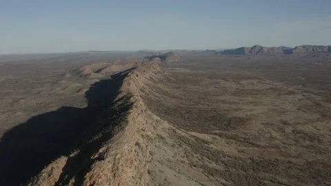 Aerial view of sharp, narrow ridgeline and plains Stock Footage 191113221