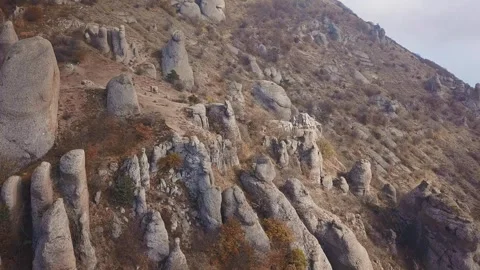Aerial view of sharp rocky outcrops at sunset. Sharp steep mountain of rock Stock Footage 246293158
