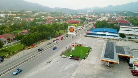 Aerial view of a Shell petrol station beside a major highway. Stock Footage 336568507