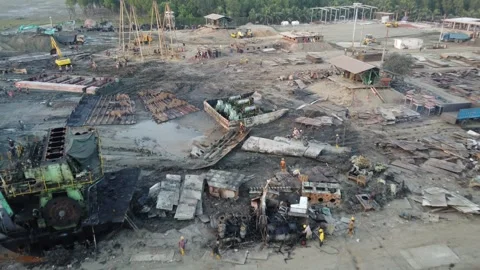 Aerial view of ship breaking yard with workers, cranes and heavy machinery Stock Footage 327162091