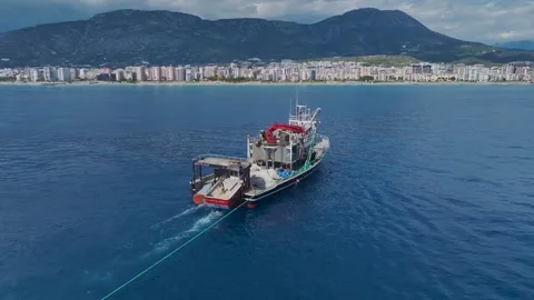 Aerial View: A ship helps maintain a fish farm by delivering oxygen to the Stock Footage 296087509