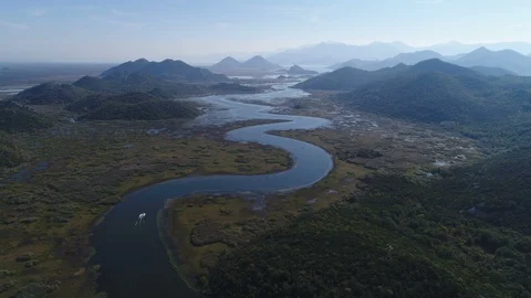 Aerial view ship sailing over meandering river national park Montenegro Stock Footage 85855616