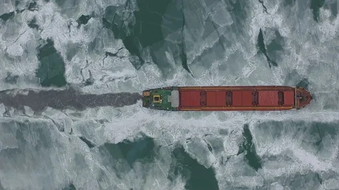 Aerial view of the ship slowly moving through ice floes Stock Footage 101789447