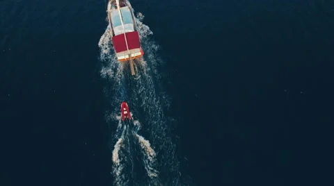 Aerial View of Ship Which Tows a Boat in Sea Bay Stock Footage 68720280
