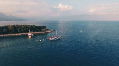 Aerial View of Ship Which Tows a Boat in Sea Bay Stock Footage 68720348