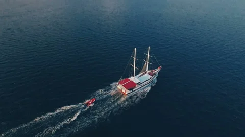 Aerial View of Ship Which Tows a Boat in Sea Bay Stock Footage 68720380
