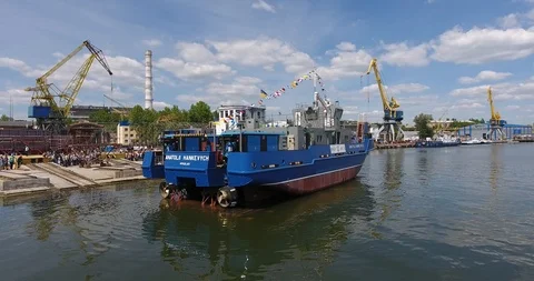 Aerial view of shipbuilding yard. Feast of launching a new river tug pusher Stock Footage 90371459