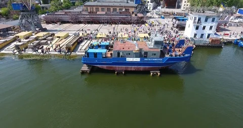 Aerial view of shipbuilding yard. Feast of launching a new river tug pusher Stock Footage 90393531