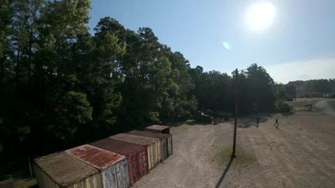 Aerial view of shipping containers in a rural industrial yard Stock Footage 346624097