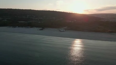 Aerial View Of Shore At Beach During Sunset in the city, Drone Moving. Stock Footage 142319081