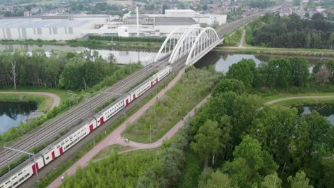 Aerial view shot by a drone of a train passing by on the railway track and over Stock Footage 222618529