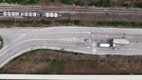 An aerial view showcases a bustling logistics hub where a freight train and Stockbeeldmateriaal 342211120