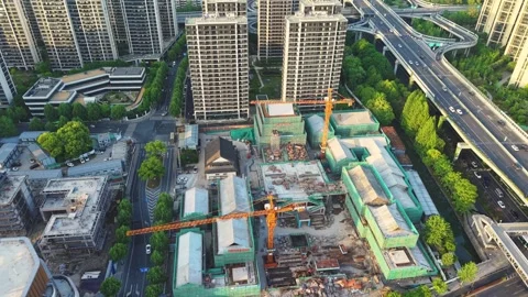 Aerial view showcases construction activity surrounding high-rise buildings in a Stock Footage 307314904