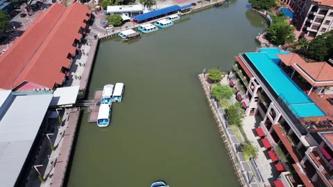 Aerial view showcases Malacca River with a cruising boat. Stock Footage 327310801
