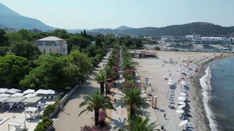 Aerial view showcasing the beach and poolside area of a beautiful coastal resort Stock Footage 294996461