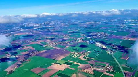 Aerial View Showcasing the Extensive Lush Green Agricultural Fields Under a Stock Photos