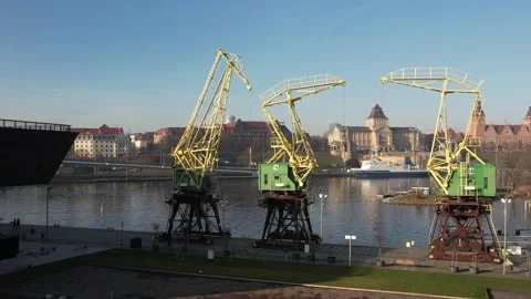Aerial view showcasing the historic cranes lining the waterfront in Szczecin 스톡 동영상 303220743
