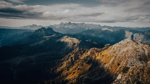 This is an aerial view showcasing a mountain range under a cloudy sky Foto stock