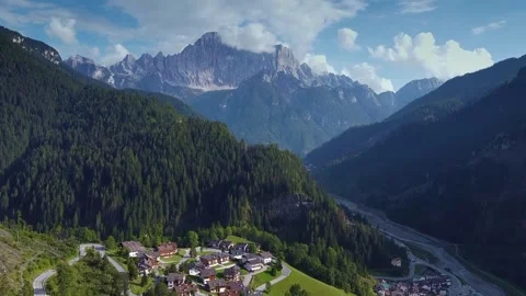 Aerial view showcasing a mountain valley village in the Dolomites Italy Video stock 342500229