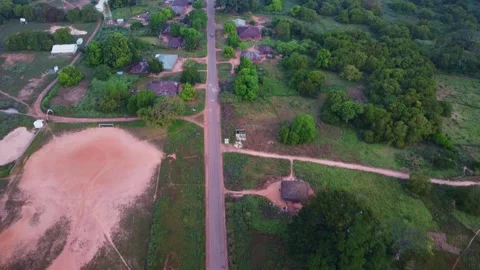 Aerial view showcasing a road bisecting a rural landscape with lush vegetation Stock Footage 318398382