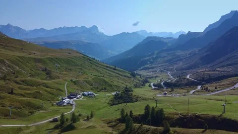 Aerial view showcasing winding roads and farms in alpine valley Video stock 342510174