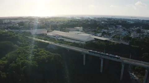 Aerial view showing Modern metro driving on bridge during sunset time in Stock Footage 235697181