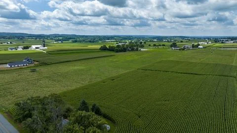Aerial View Showing A Patchwork Of Crop Fields, Farmsteads, A Serpentine Road Stock Photos