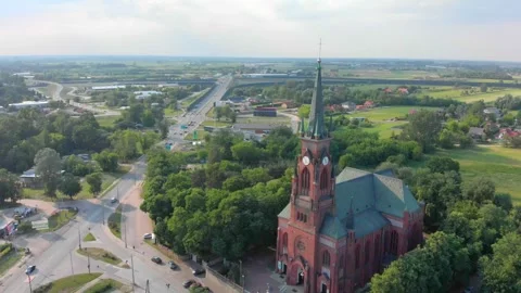 Aerial View Showing Red Brick Church with Clock Tower in Rural Area Stock Footage 340040081