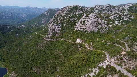 Aerial View Showing Small Building and Roads on Mountain Ridge in Montenegro Stock-Footage 342772024