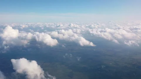 Aerial view showing white fluffy clouds over land and water at daytime Video stock 342022949