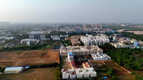 This aerial view shows a developing urban area. In the foreground is open Video stock 310336600