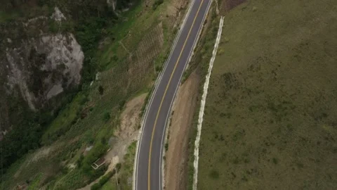 Aerial view that shows an empty highway along a hillside Stock Footage 142755329