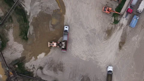 An aerial view shows heavy construction vehicles operating at an industrial Stock Footage 345958475
