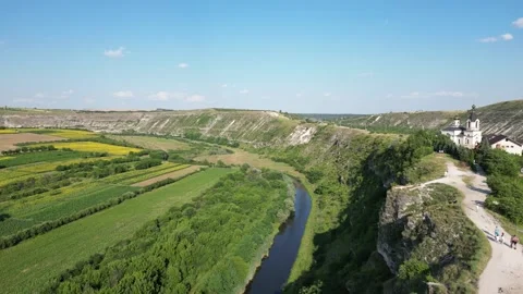 Aerial view shows a river flowing through a valley Stock Footage 340240283