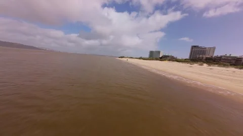 Aerial view shows sandy beach with river running through Stock Footage 345060064