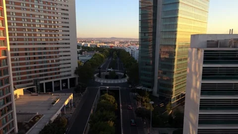 Aerial view shows sleek office buildings bathed in golden hour light; Expo Video stock 346070863