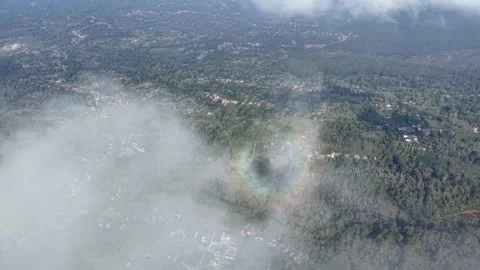 Aerial view shows a vibrant rainbow arching above misty clouds Stock Footage 345499582