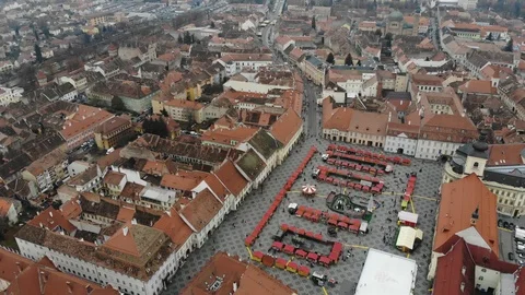 Aerial view of Sibiu's main square with the winter market, skating rink and c Stock Footage 124550659
