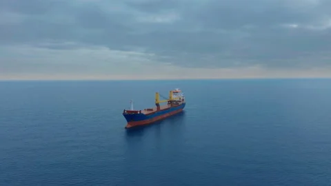 Aerial view. Side view of red cargo ship floating in the sea. Stock Footage 140899184