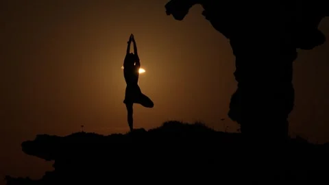 Aerial view of silhouette doing yoga during solar eclipse, Spain. Stock Footage 342480912