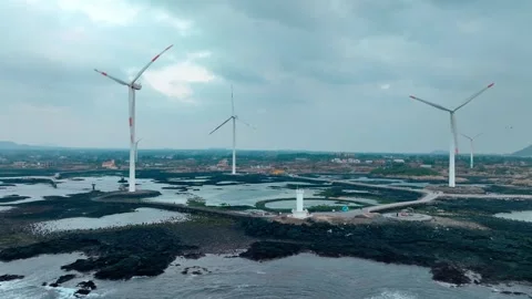 Aerial view of Sinchang Windmill Coast in Jeju Island, Wind turbine Stock Footage 296497683
